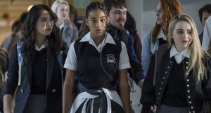 A girl looking shocked in a school uniform in a crowd at school