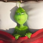 The Grinch laying in bed grumpily