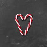 Two candy canes that are in a heart shape
