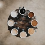 Different colors of coffee on a table in a circle