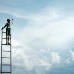 Kid standing on a ladder reaching for the clouds