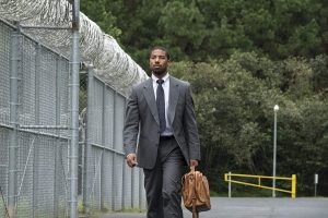 Michael B. Jordan walking outside of a jail