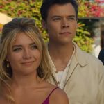 A snapshot from the film Don't Worry Darling, featuring costars Florence Pugh and Harry Styles looking at the camera