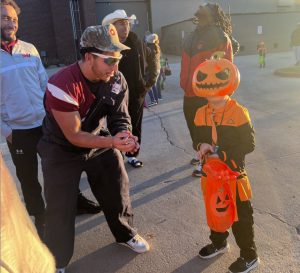 Football team handing out candy-Joah Flroes