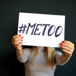 A girl holding up a sign with #MeToo on it