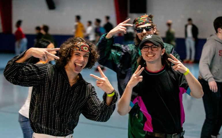 Three students dressed as hippies at Roller Rag